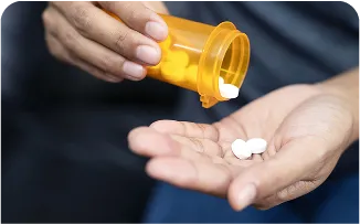 person-holding-pills