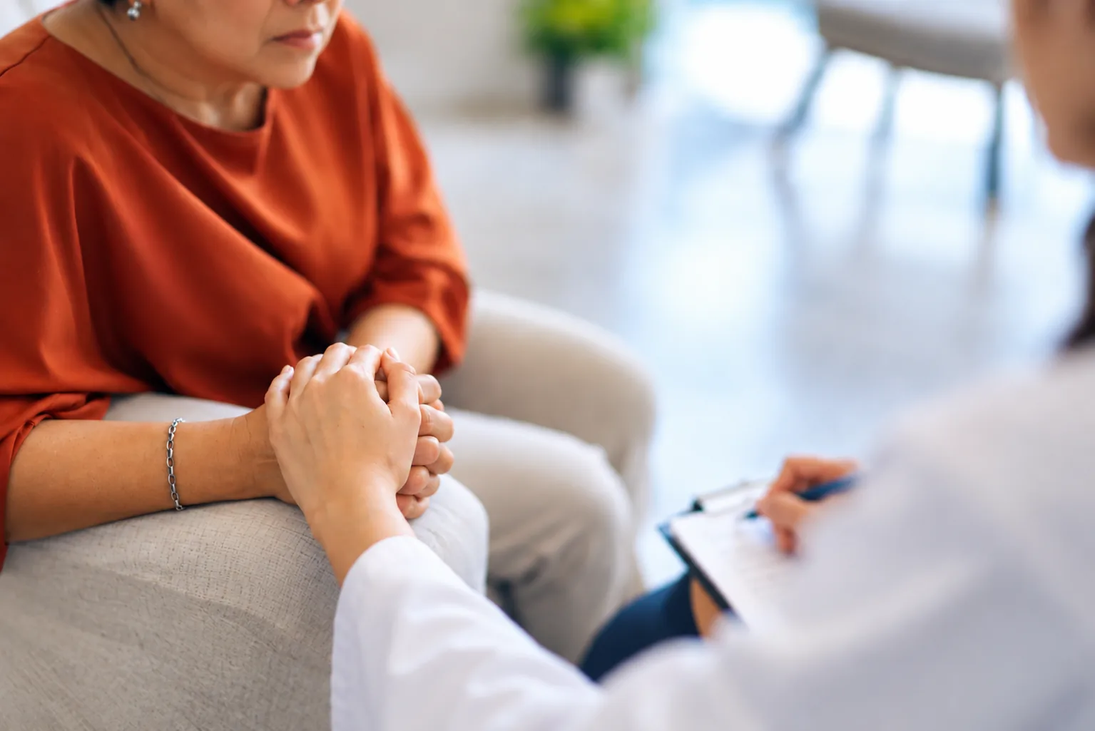 Woman receiving support from a healthcare professional during a PTSD consultation